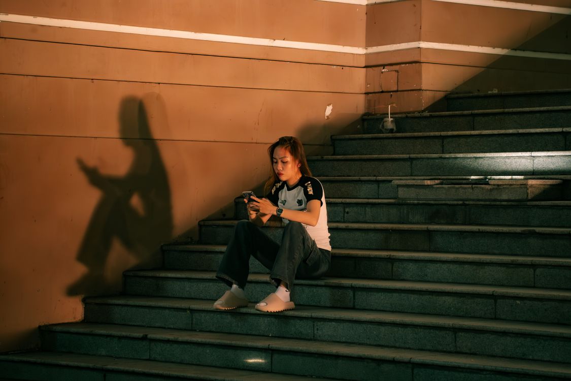 Shadow Relaxing Young Woman Relaxing on Urban Staircase with Shadow · Free Stock Photo