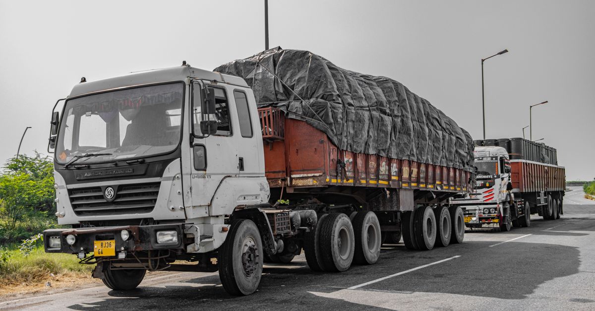 Heavy cargo trucks parked on a highway in Deeg, Uttar Pradesh, India, showcasing Indian logistics.