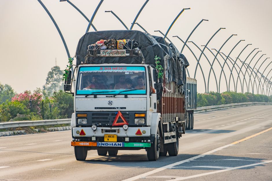 White truck on Deeg expressway, Uttar Pradesh, India transporting goods.