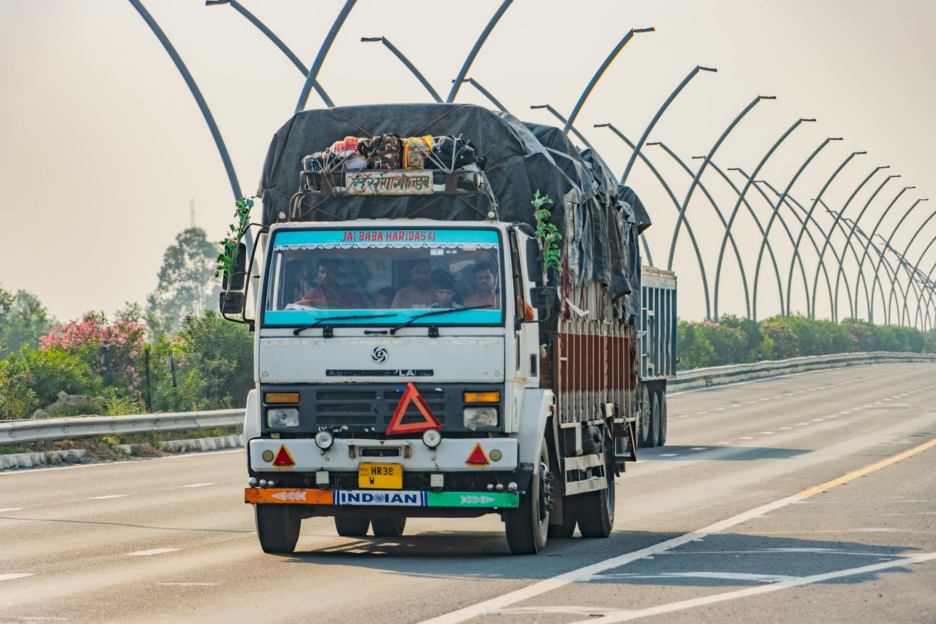 White truck on Deeg expressway, Uttar Pradesh, India transporting goods.