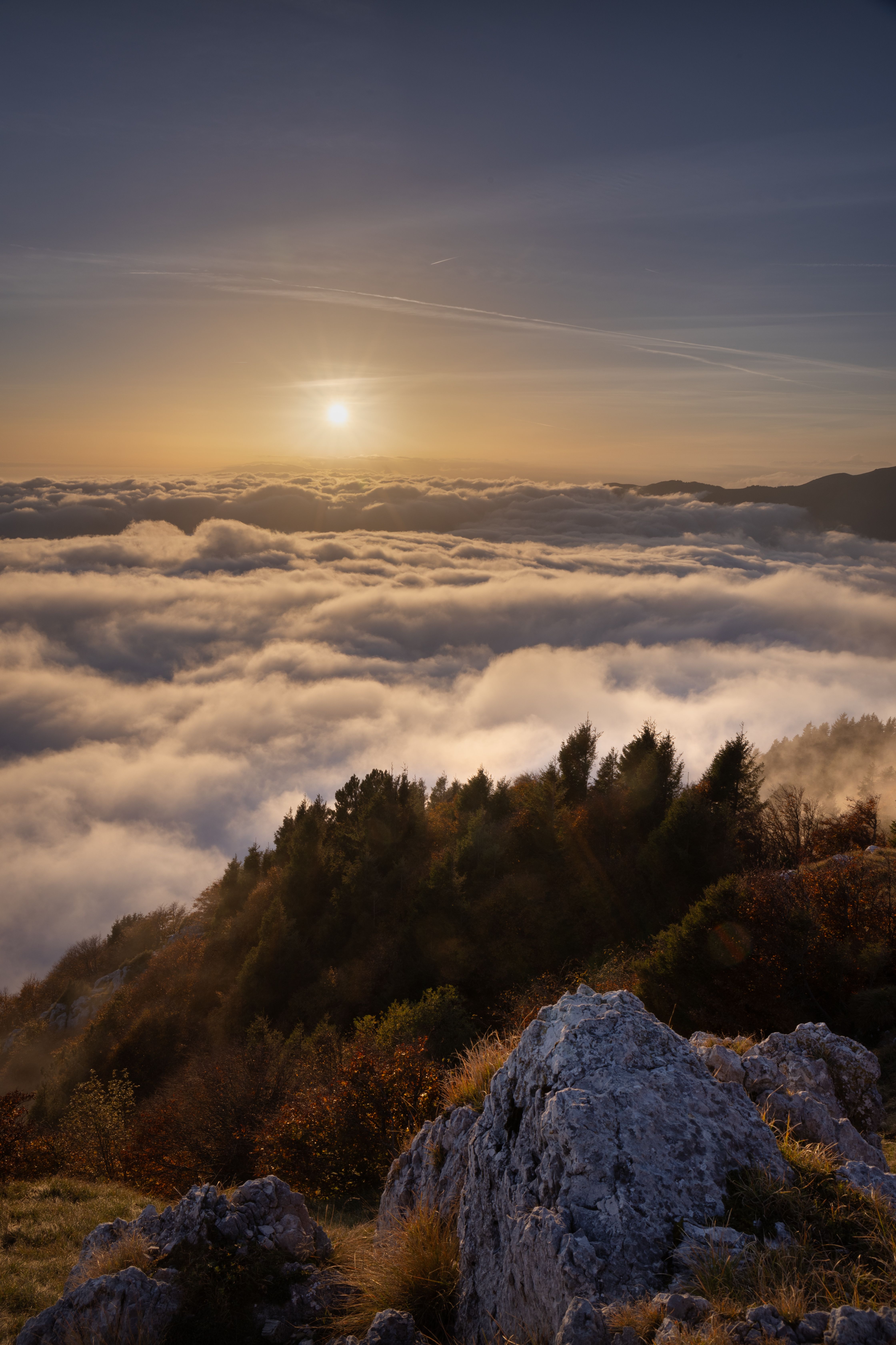 Breathtaking view of a sunset over clouds and mountains in Fregona, Veneto, Italy.