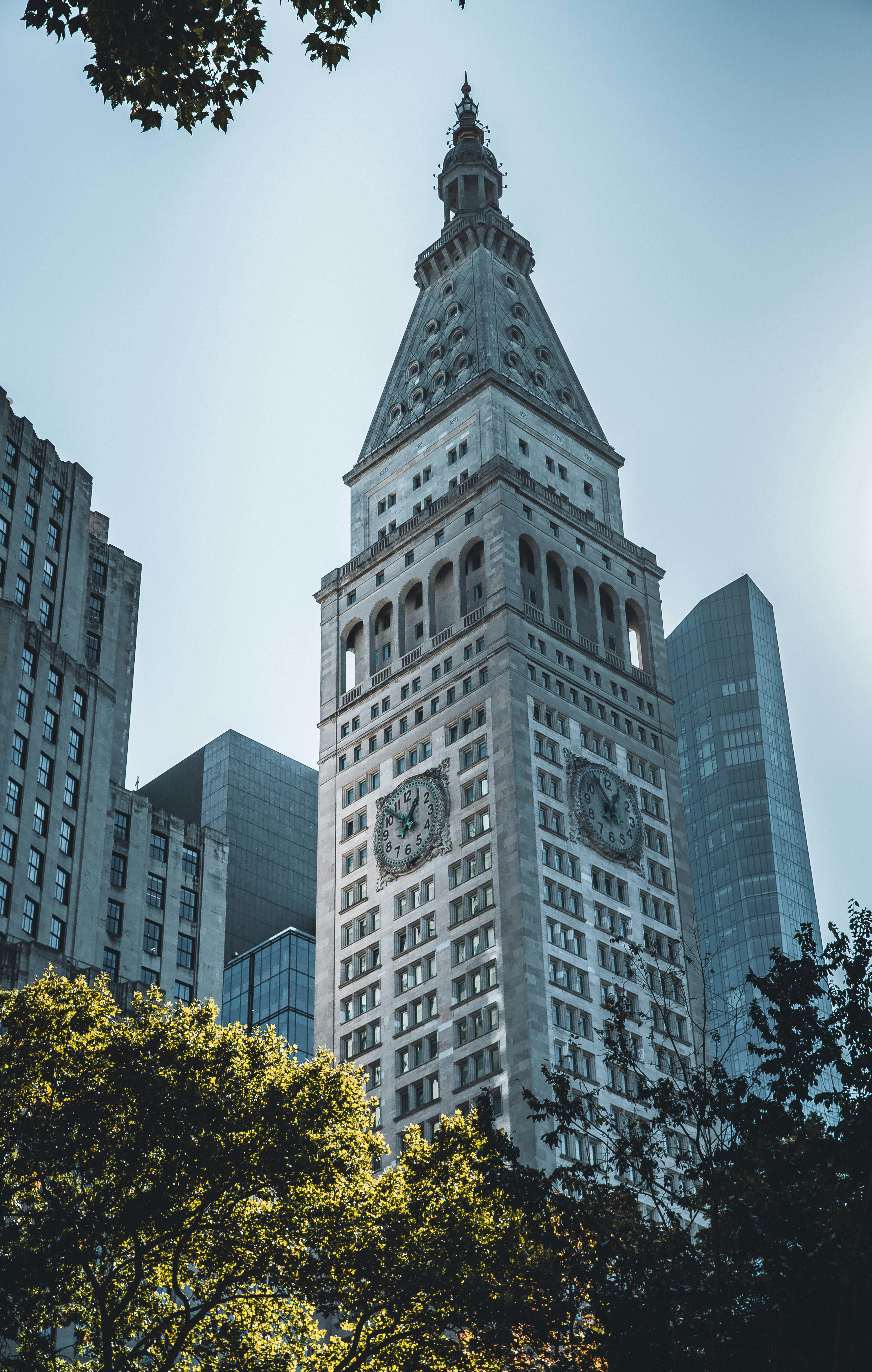 The iconic Metropolitan Life Tower rises prominently in New York City, surrounded by modern skyscrapers.