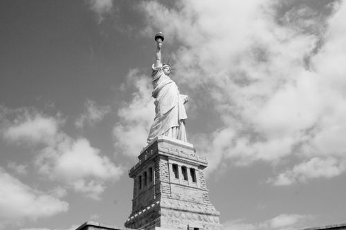 Free Black and white image of the Statue of Liberty with a cloudy sky in New York City. Stock Photo