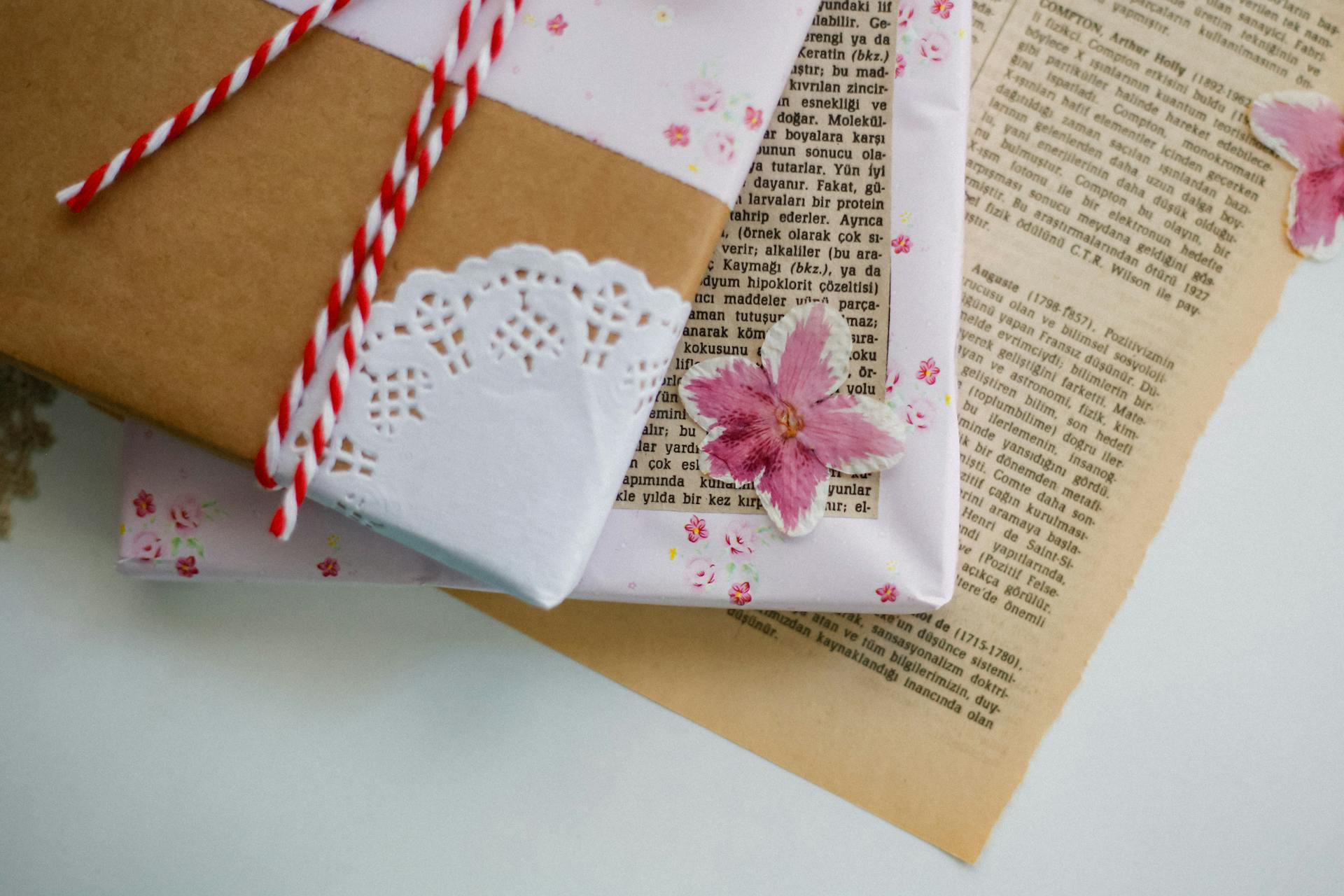 A close-up of intricately wrapped gift boxes with floral paper and vintage accents, perfect for any occasion.