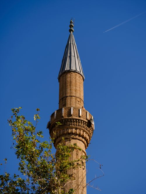 Free A historic minaret rises against a clear blue sky in Antalya, showcasing Islamic architecture. Stock Photo