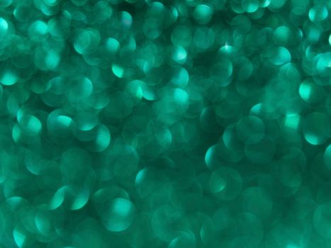 Vibrant green bokeh lights create a dreamy abstract background.