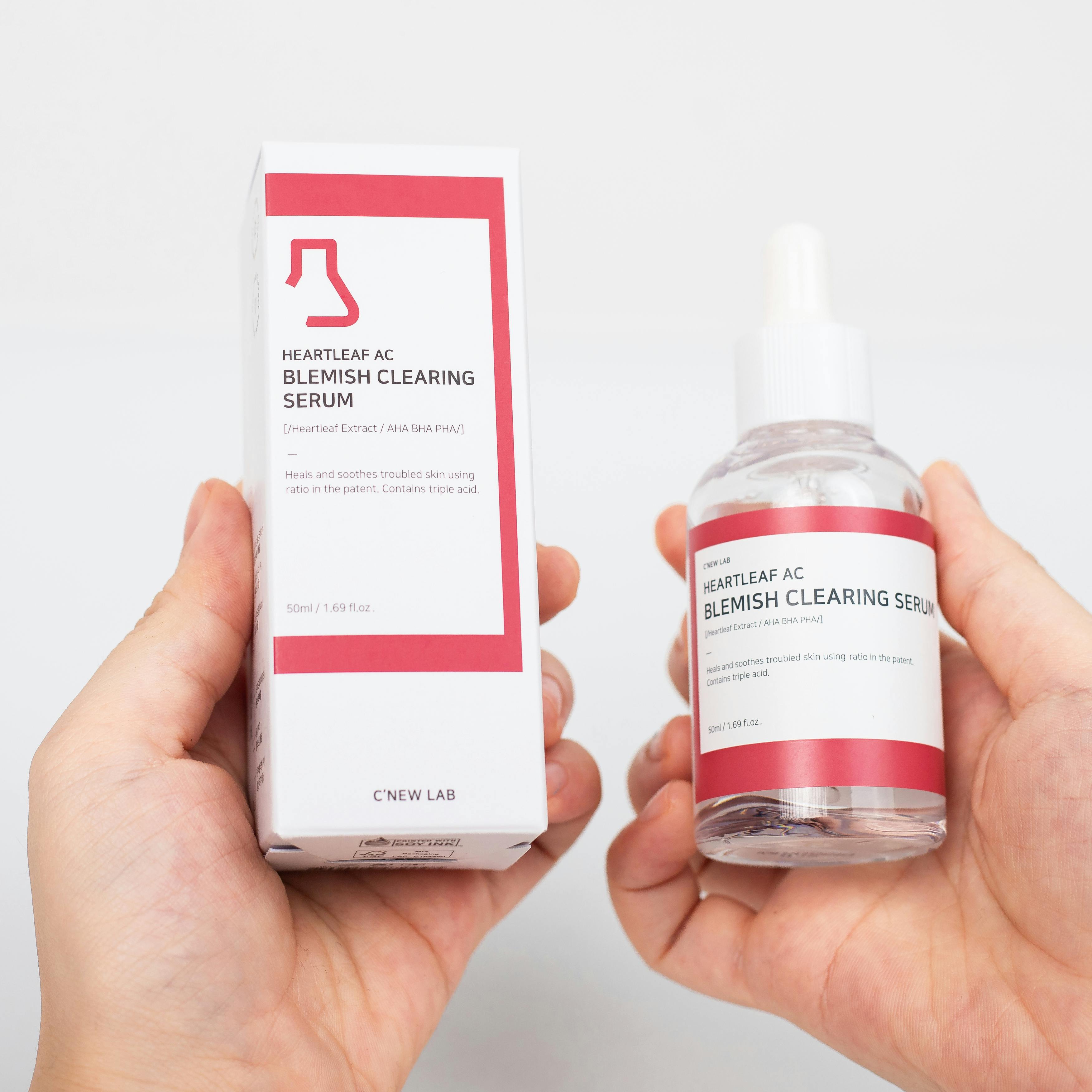 Close-up of Heartleaf AC blemish clearing serum and box on white background.