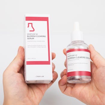 Close-up of Heartleaf AC blemish clearing serum and box on white background.