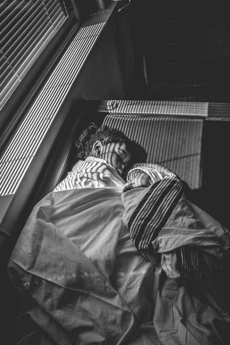 Grayscale Photography Of Toddler And Baby Sleeping