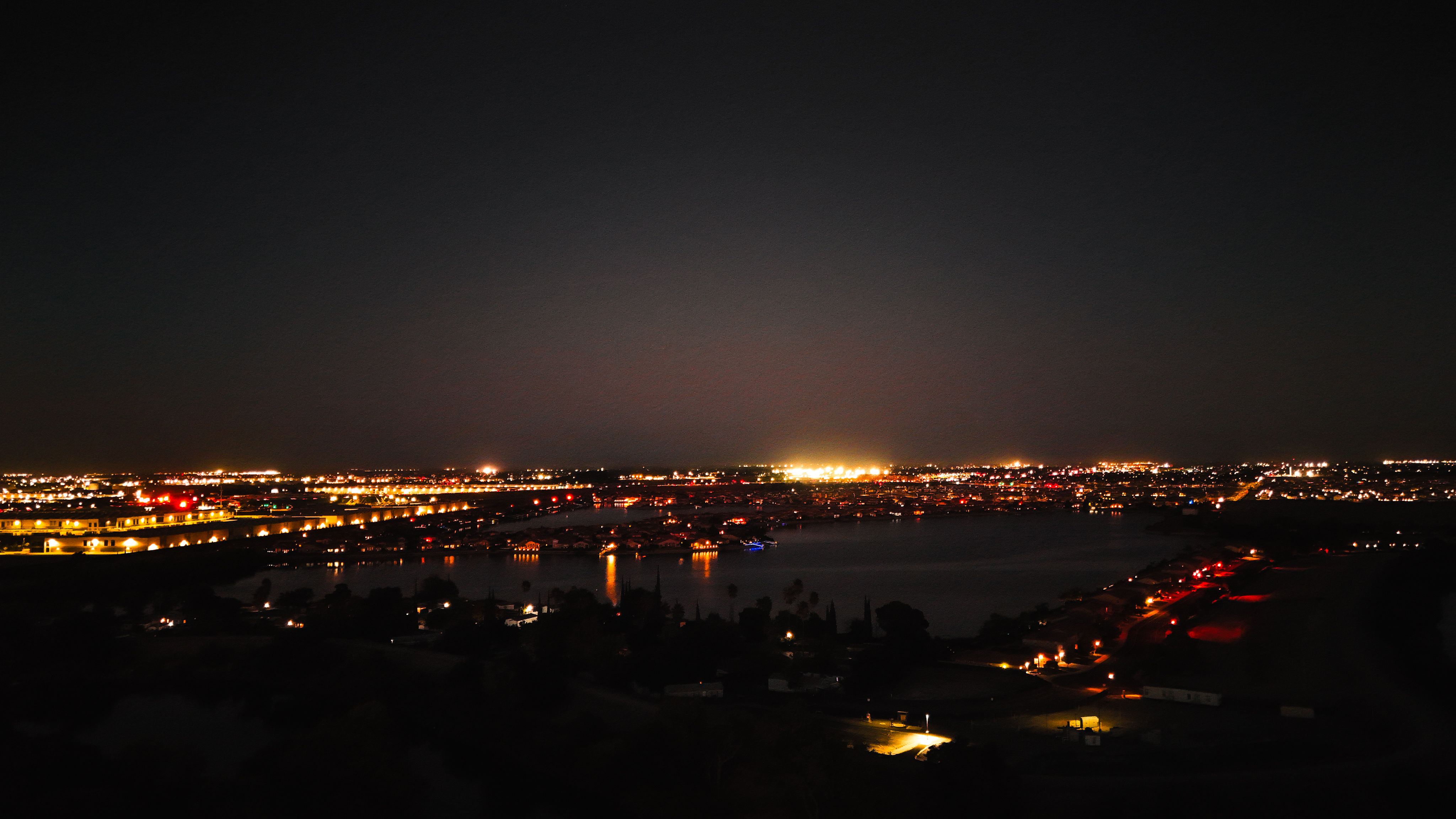 Aerial Night View of Cityscape and Water Reflections · Free Stock Photo