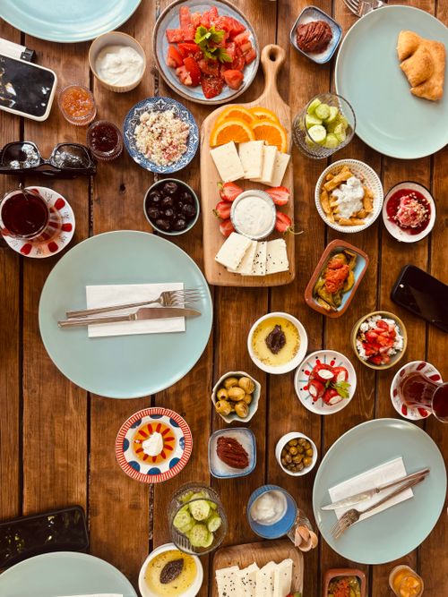 Free Flat lay of a vibrant Turkish breakfast with a variety of dishes on a rustic wooden table. Stock Photo