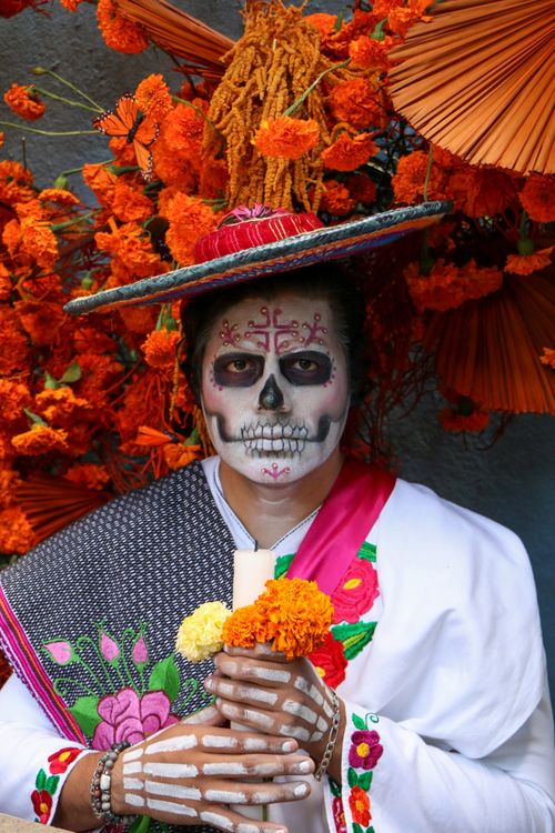 Free Vibrant portrait capturing the essence of Dia de los Muertos with traditional makeup and marigold flowers. Stock Photo