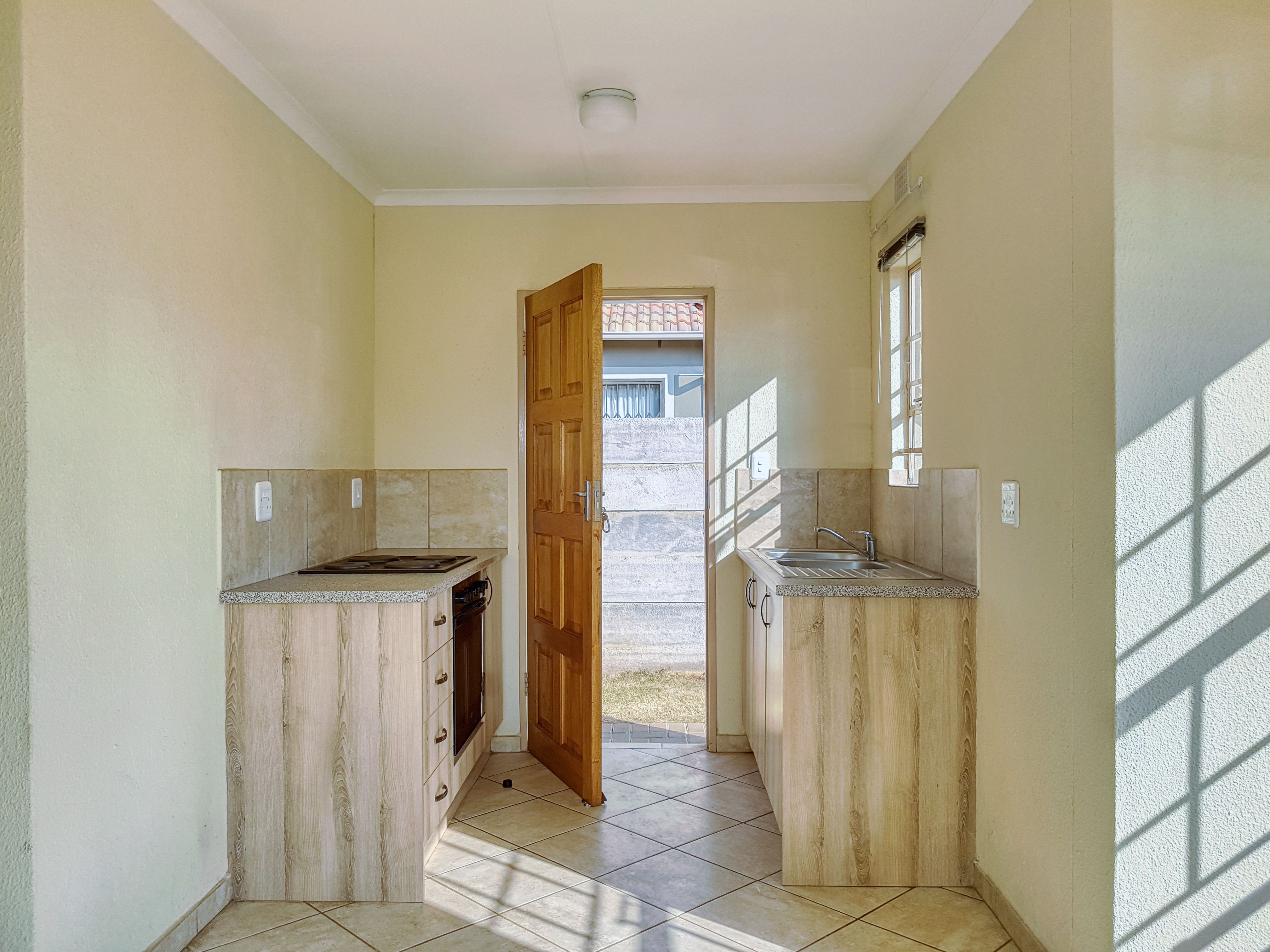 Small kitchenette with gas ring and fridge in a highland Honduran apartment rental