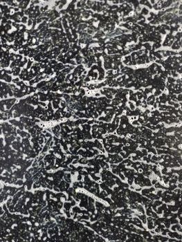 Abstract image featuring white bubbles on a dark background creating a complex texture.