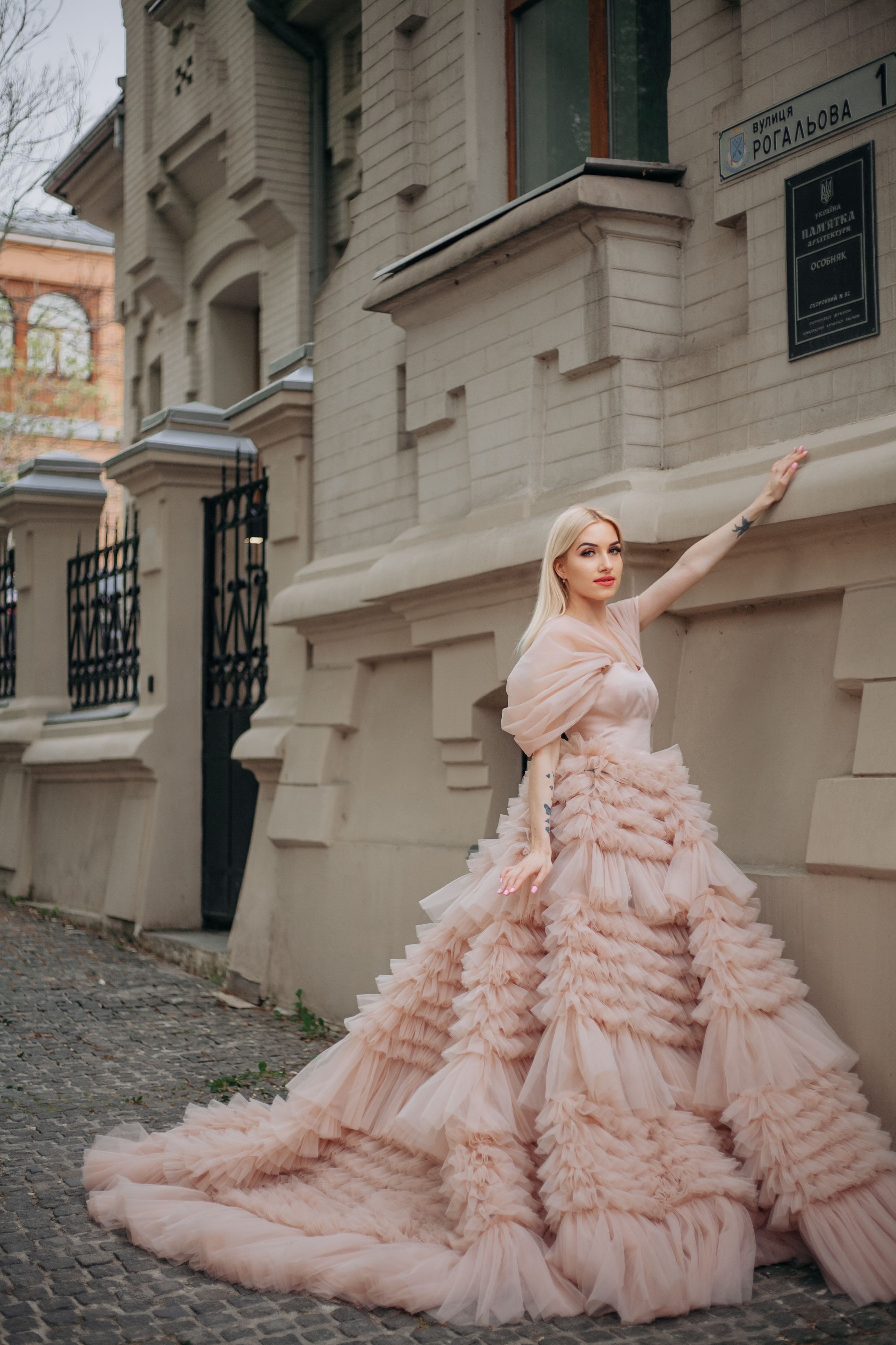Elegant Woman in Ruffled Gown on Urban Street