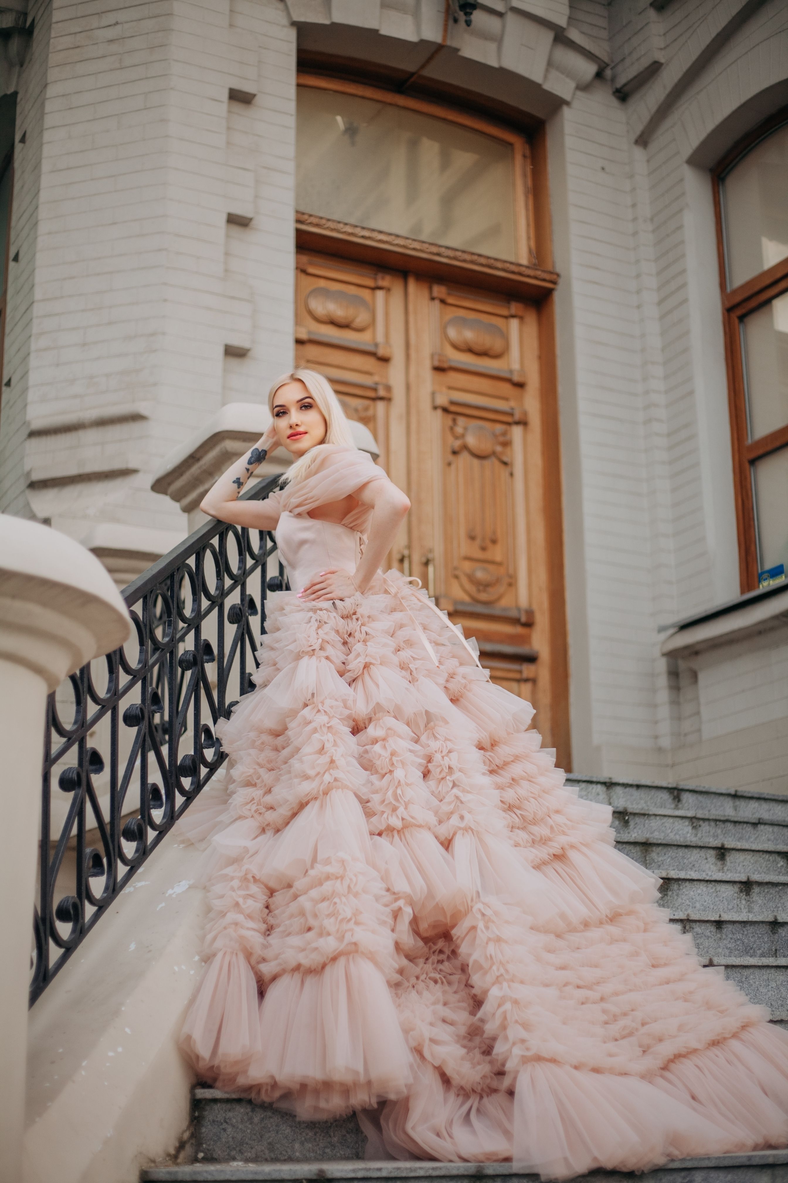 Elegant Woman in Flowing Gown on Staircase
