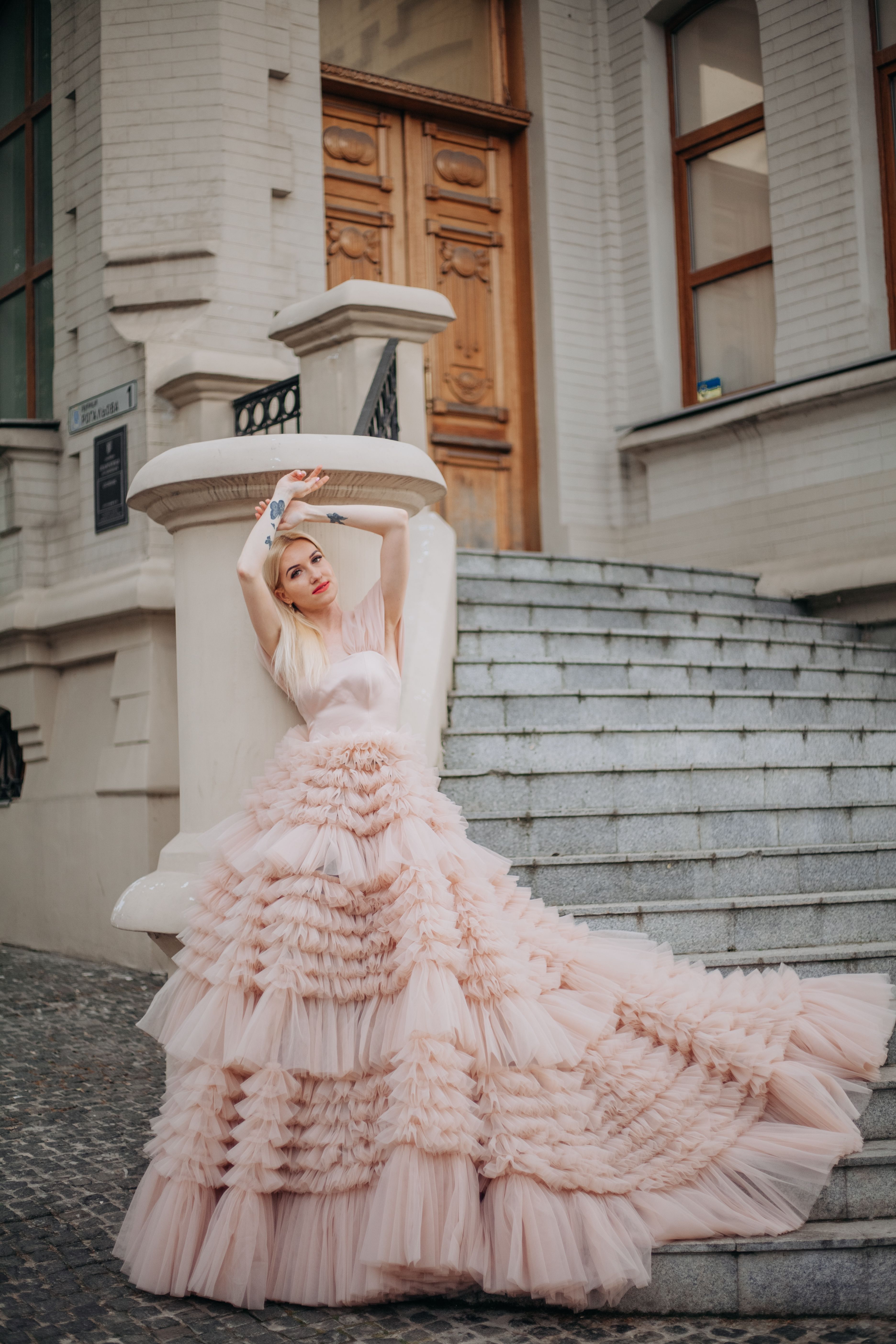 Elegant Woman in Pink Ruffled Dress Posing Outdoors