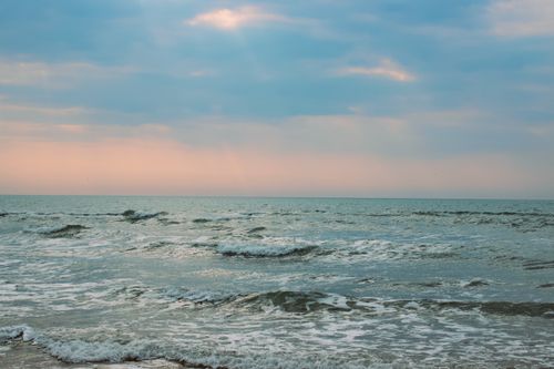 Free Serene waves under a pastel sky at sunset on the French coast, evoking tranquility. Stock Photo