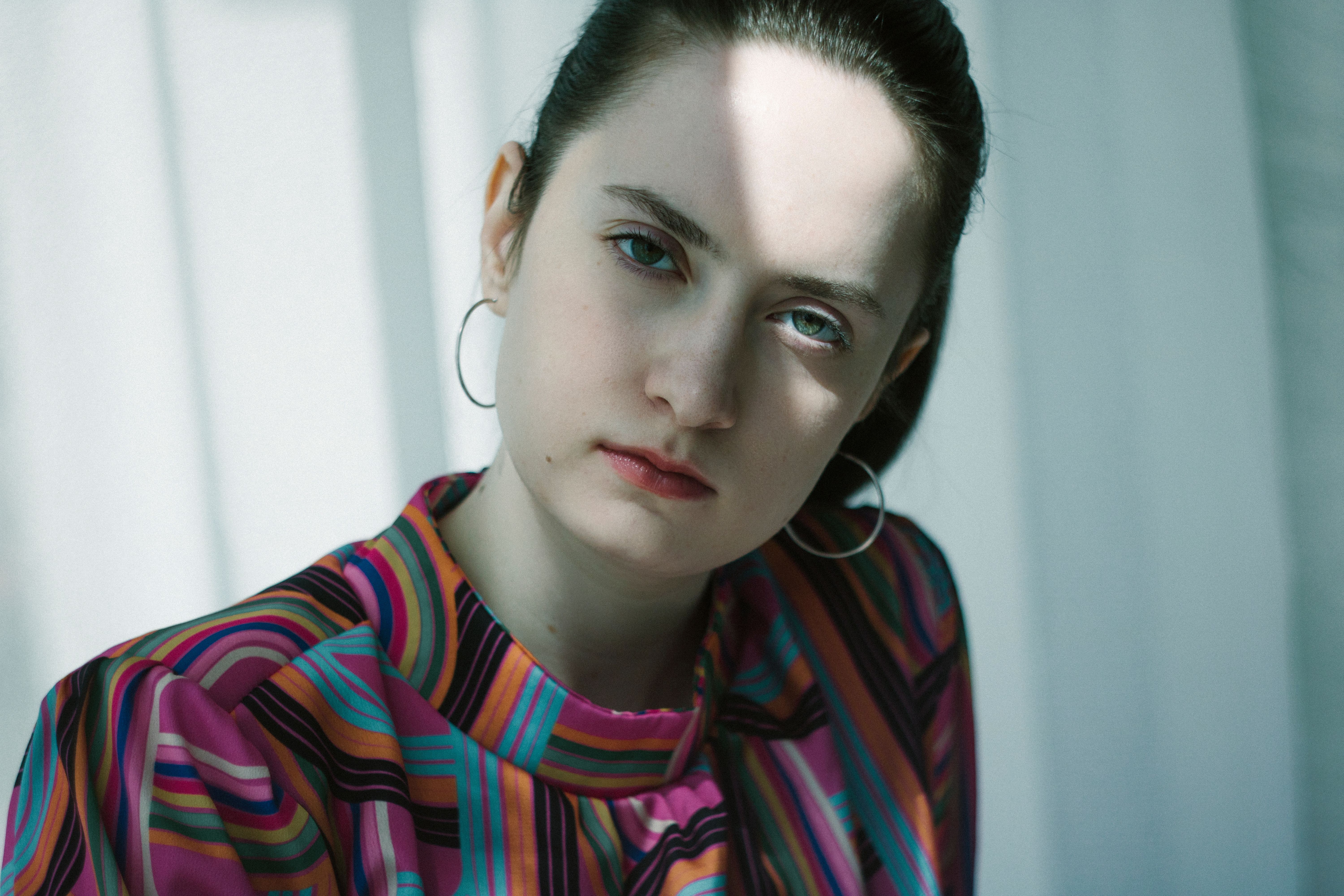 Young Woman in Striped Shirt with Soft Lighting · Free Stock Photo