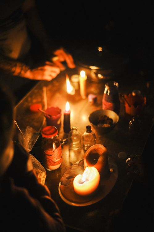 Pendant light over a tiny dining table Cozy candlelit dining table with a warm pendant light above