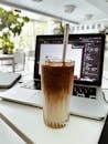 Iced coffee on a creative workspace table