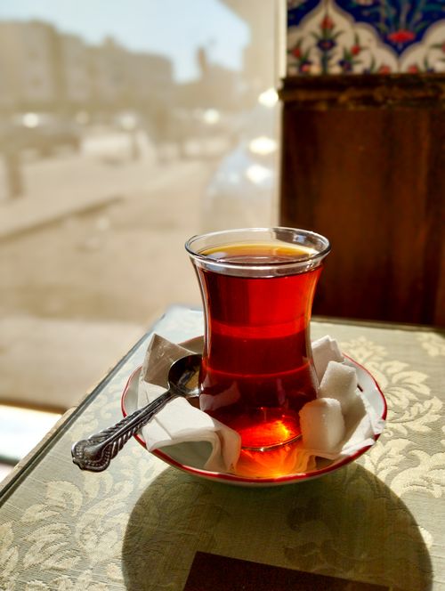 Free A glass of Turkish tea with sugar cubes on a table, capturing a cozy cafe vibe. Stock Photo