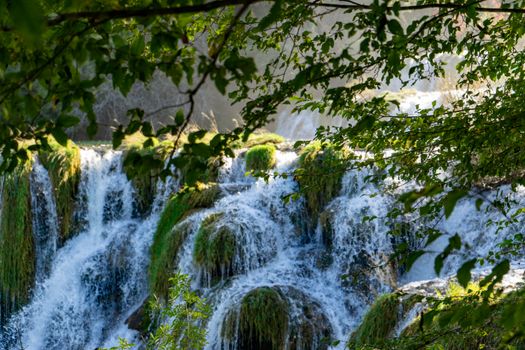 Beautiful waterfall scene in Krka National Park, Croatia, framed by lush greenery.