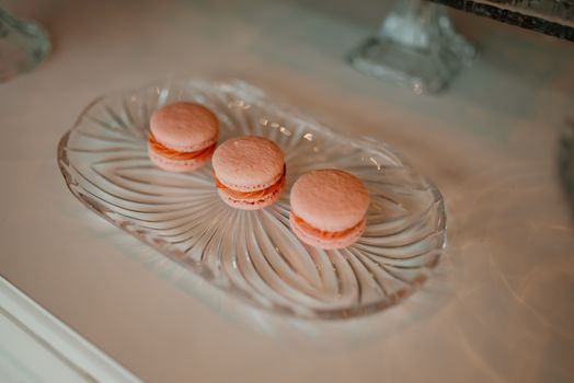 Delicate Pink Macarons on Elegant Glass Plate