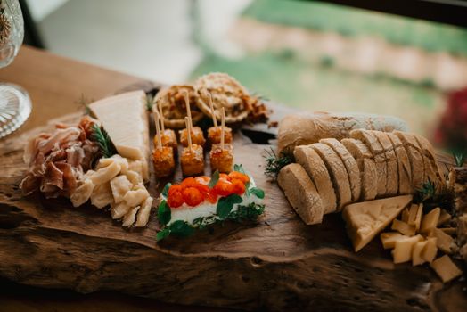 A beautifully arranged charcuterie board featuring cheeses, meats, and bread, perfect for gourmet dining.