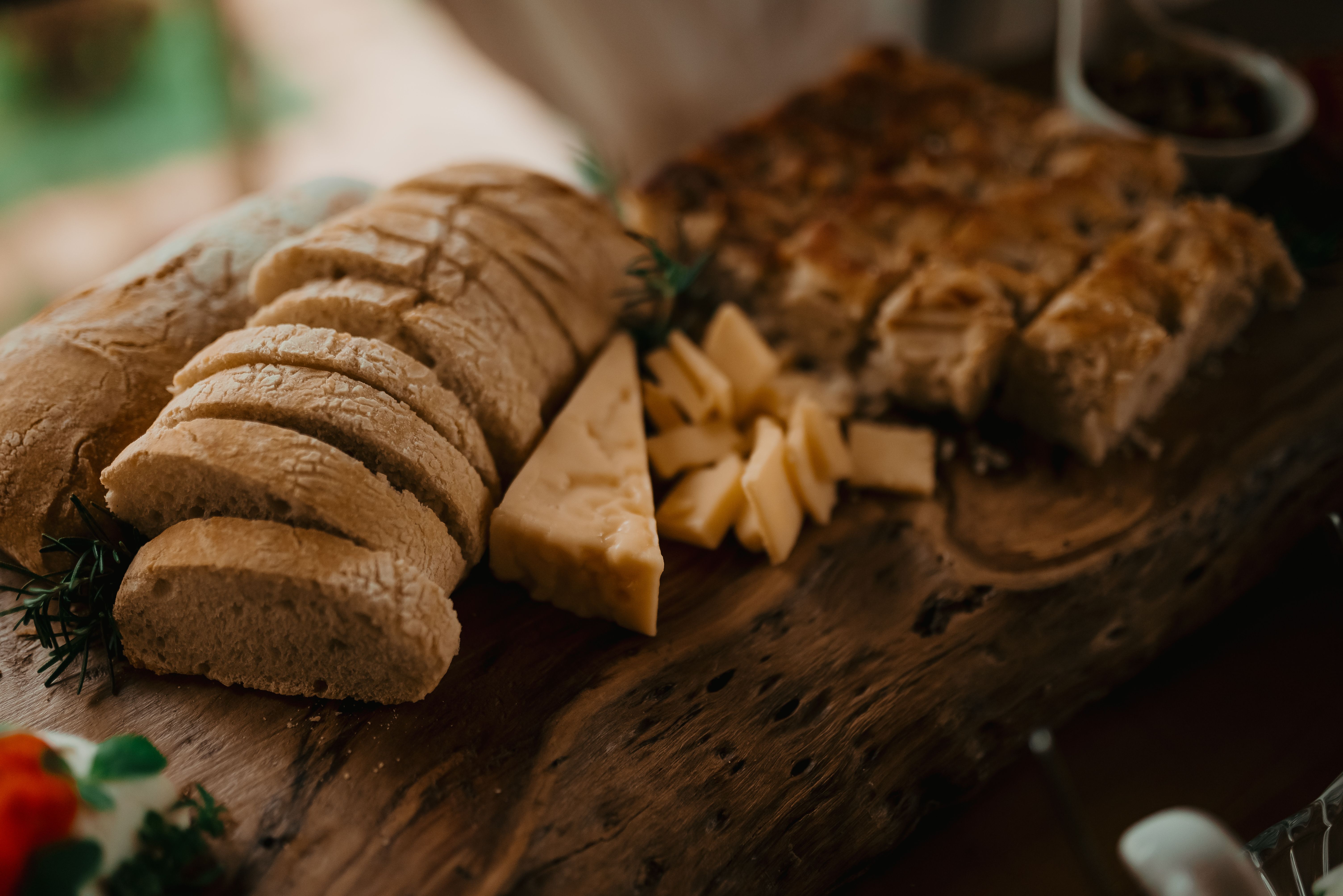 Sliced Bread and Cheese on Rustic Wooden Board · Free Stock Photo