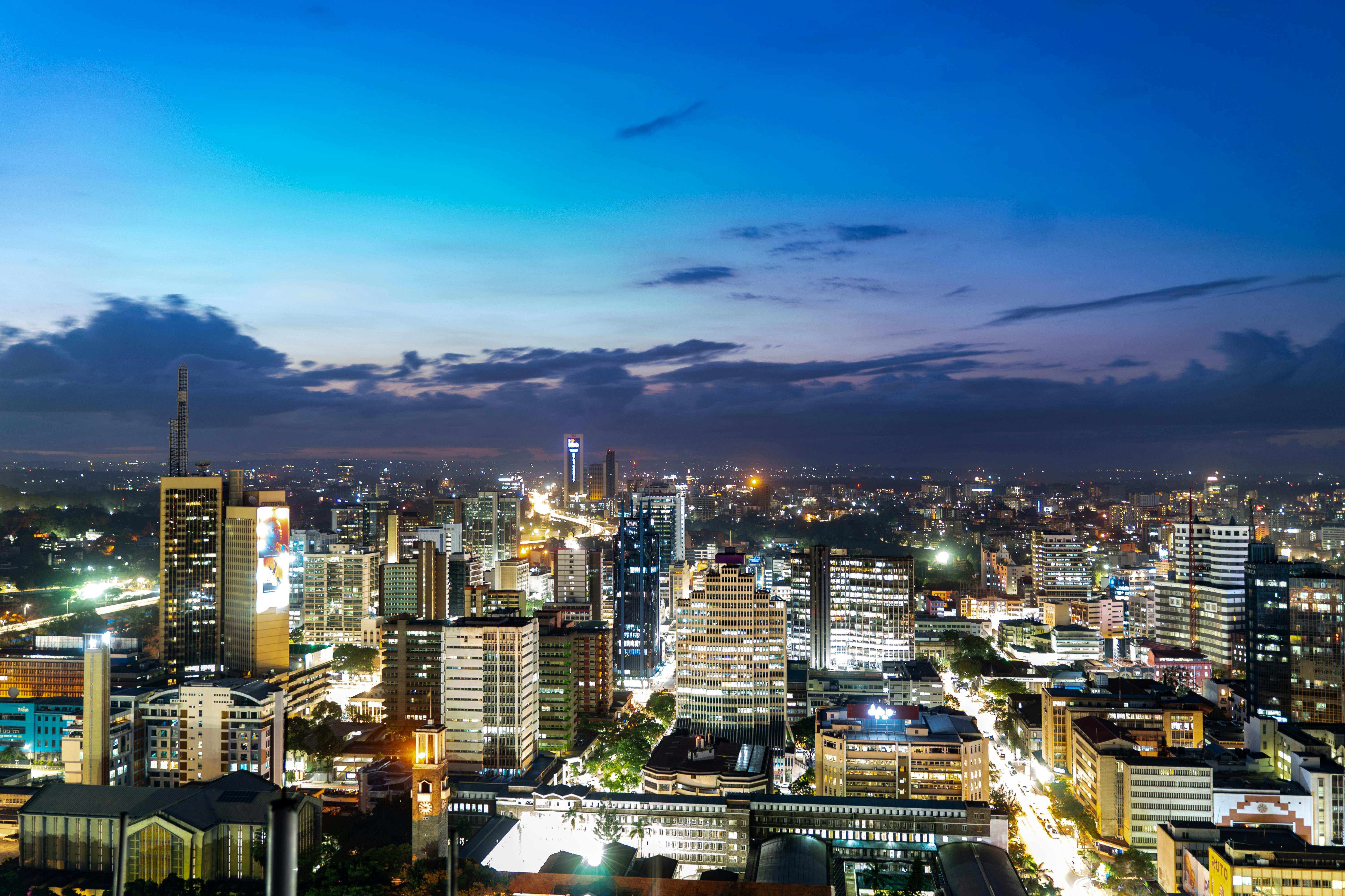 Breathtaking view of Nairobi's skyline during twilight, showcasing vibrant city lights.