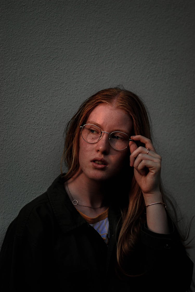 Portrait Of Woman Holding Her Eyeglasses