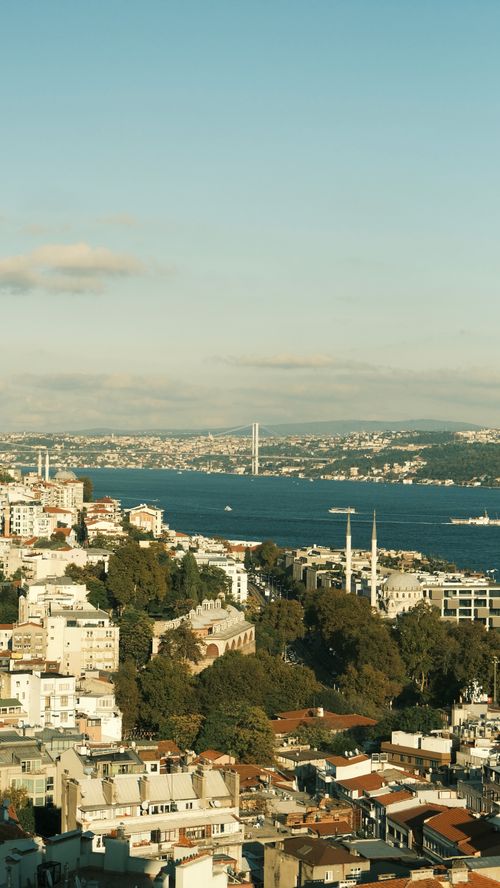 Free A scenic aerial view of Istanbul featuring the Bosphorus Bridge and bustling city life. Stock Photo