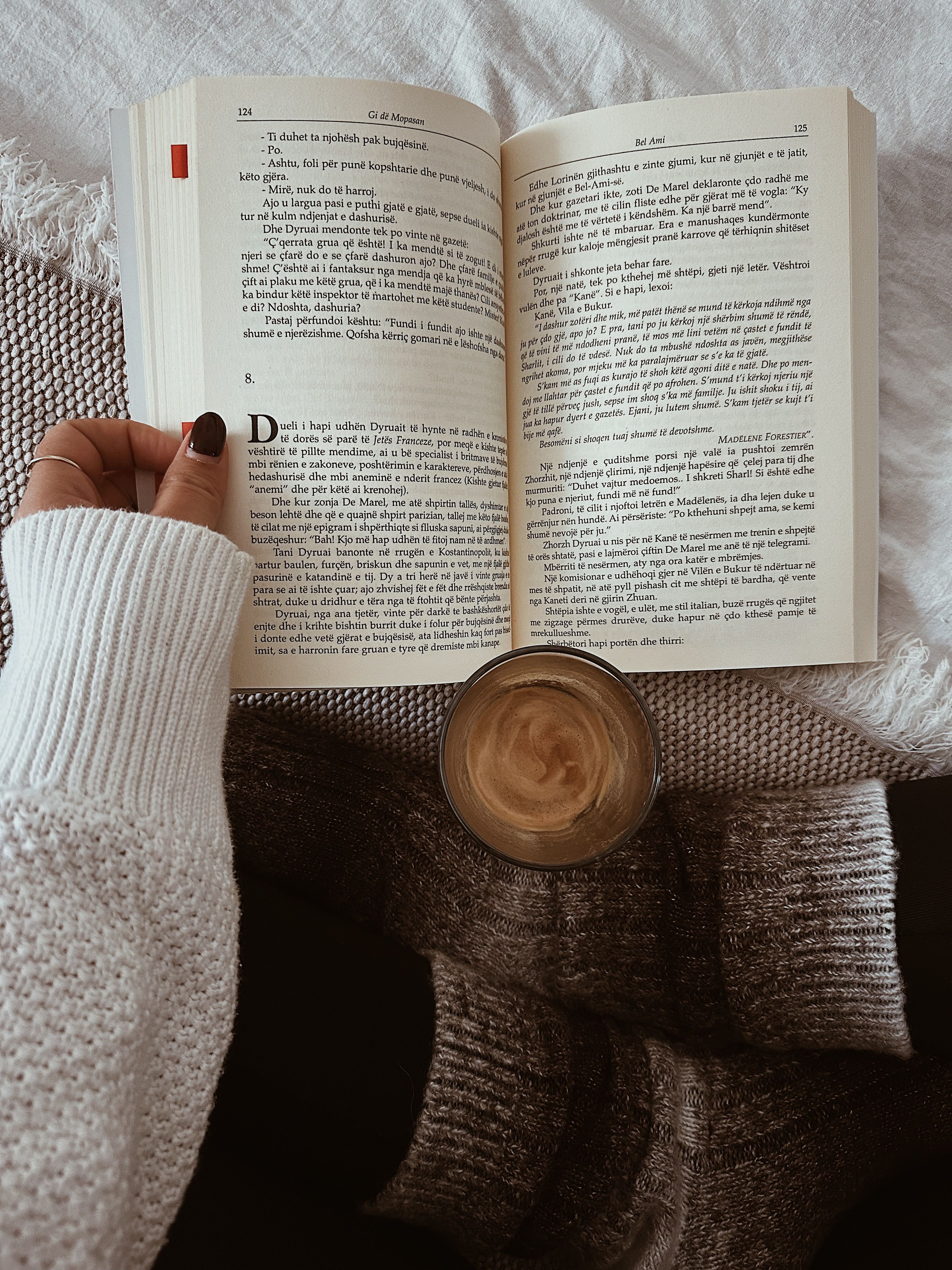 Warm cozy scene with book, coffee, and comfort socks indoors.