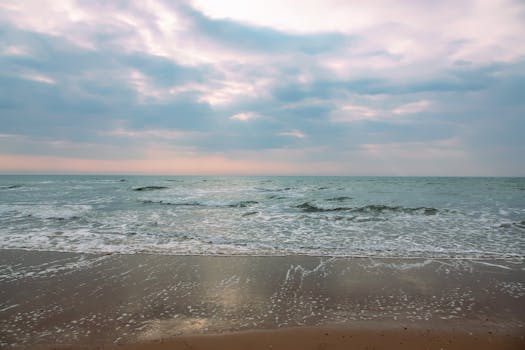 Tranquil sea waves at a peaceful beach in Royan, France during the day.
