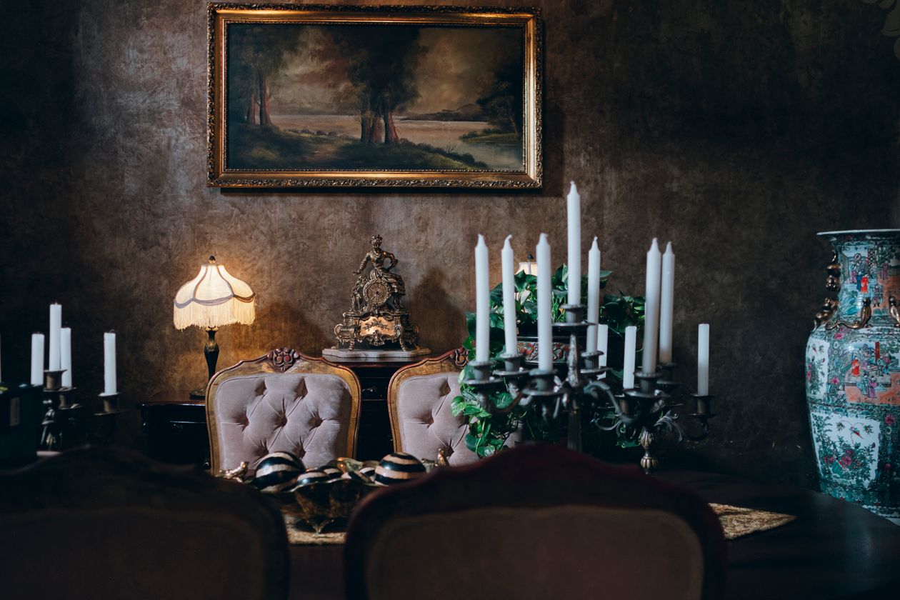 Candlelit vintage dining room with tufted upholstered chairs