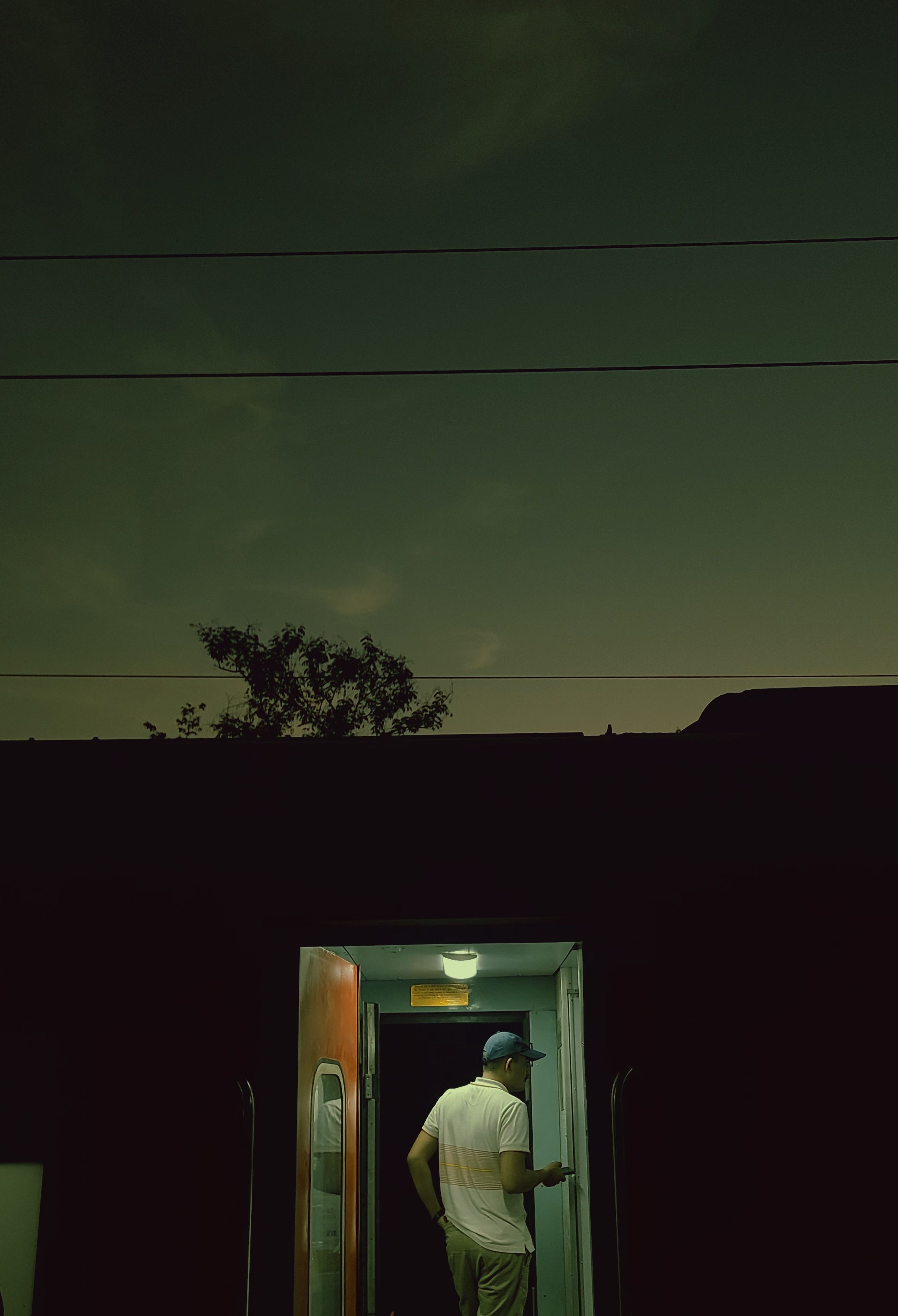 Person Standing in Dimly Lit Train Car · Free Stock Photo