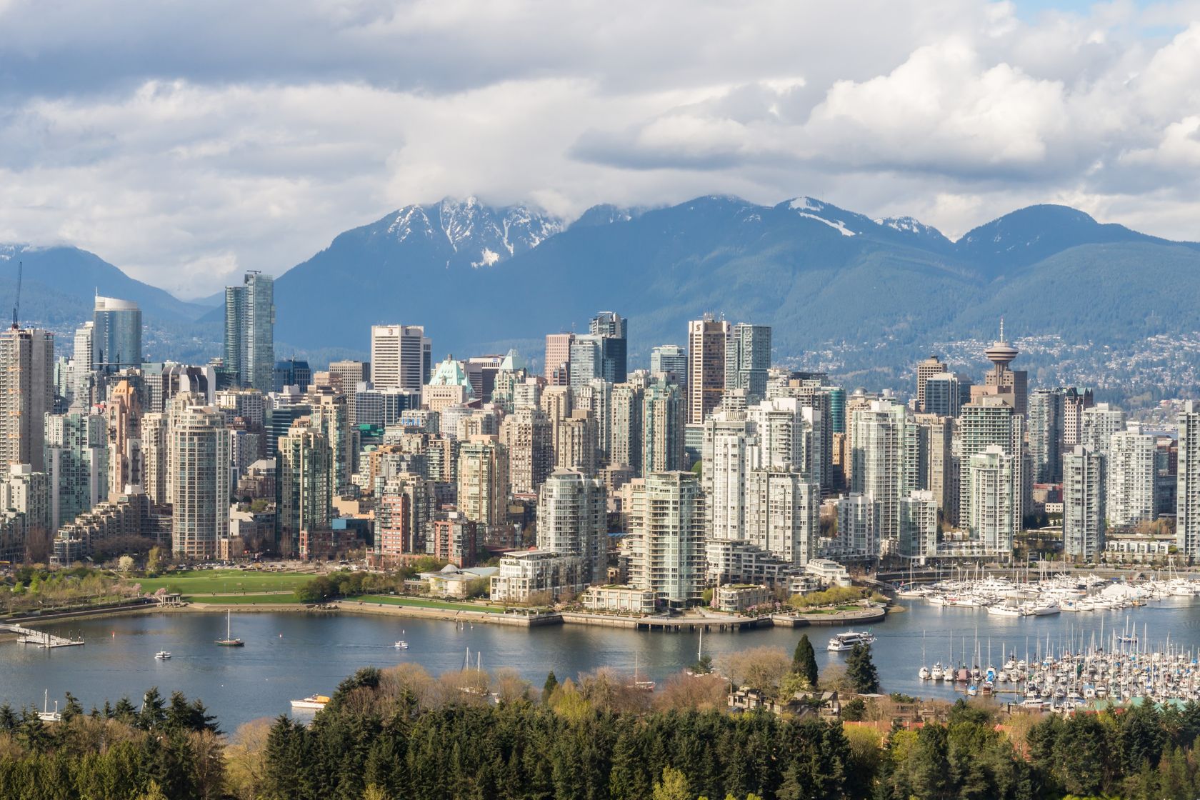 Stunning view of Vancouver's skyline with mountains and marina in the background.