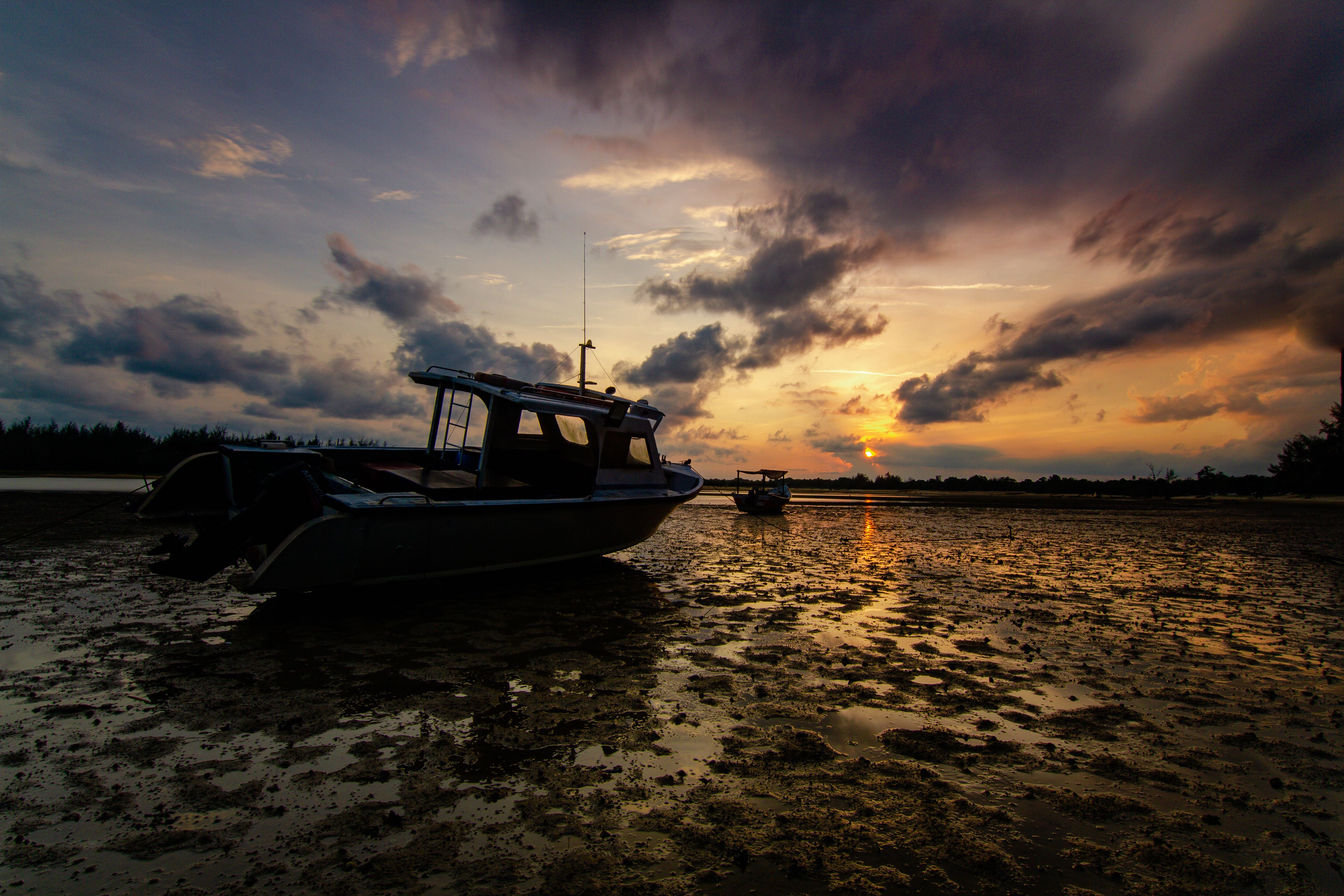 Serene Sunset Over Beached Fishing Boat · Free Stock Photo