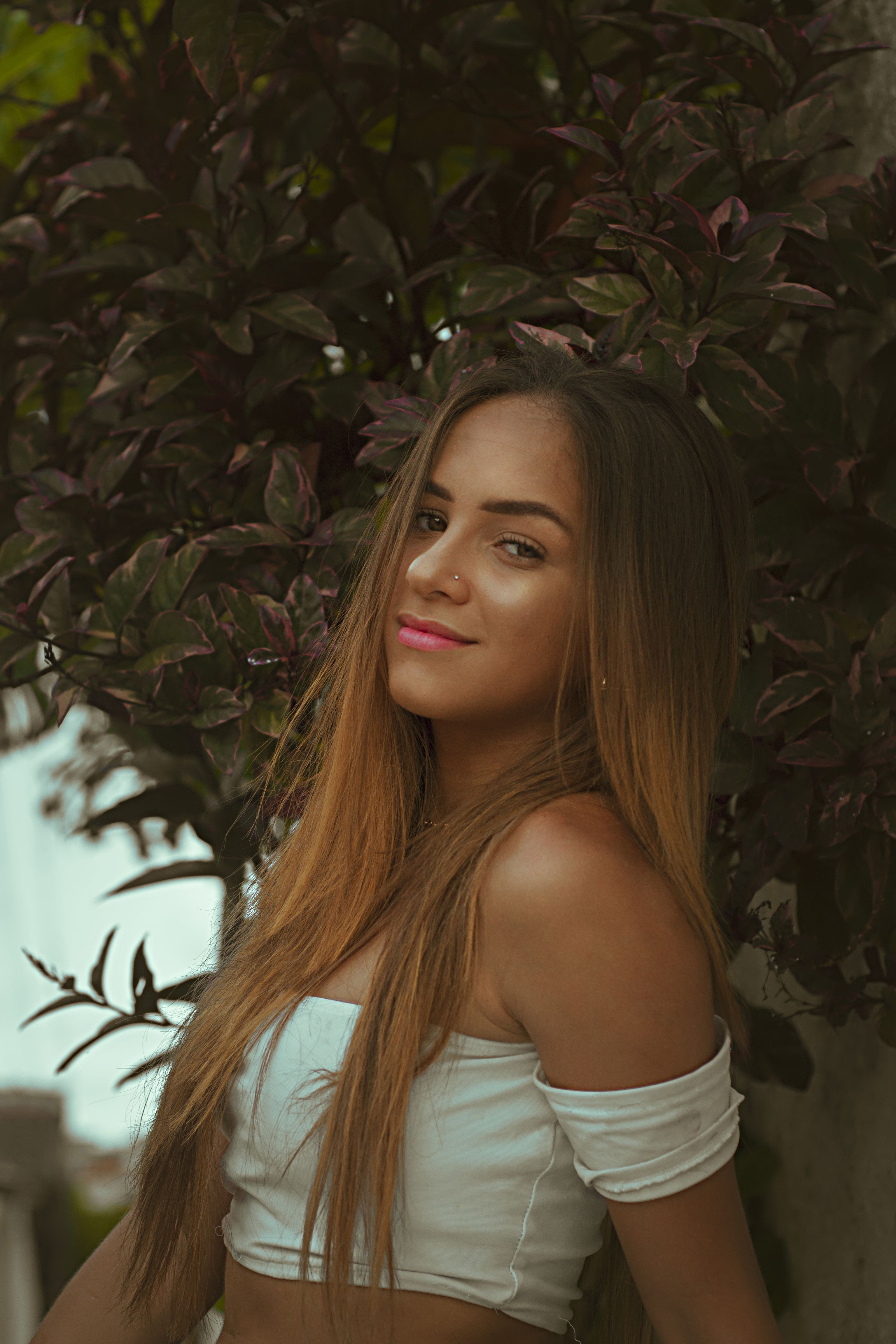 Portrait of a Smiling Young Woman Outdoors · Free Stock Photo
