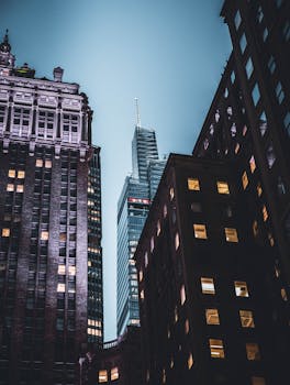 Cityscape view of New York skyscrapers against a twilight sky, showcasing urban architecture.