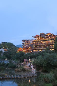 A beautiful view of traditional Chinese architecture illuminated at twilight in Hunan Province, China.