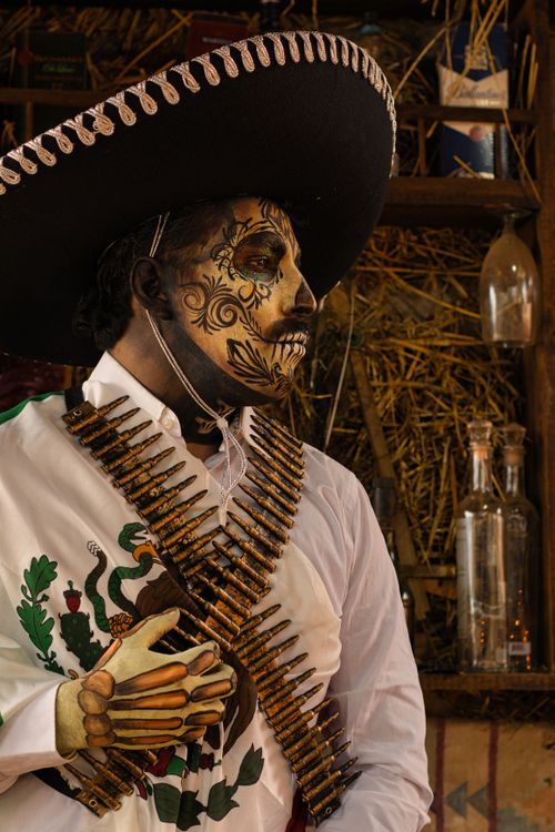 Free Person in Day of the Dead costume with intricate face paint and sombrero. Stock Photo