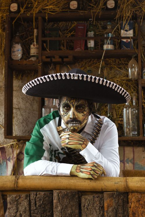 Free Portrait of a person in traditional Day of the Dead attire with face paint. Stock Photo