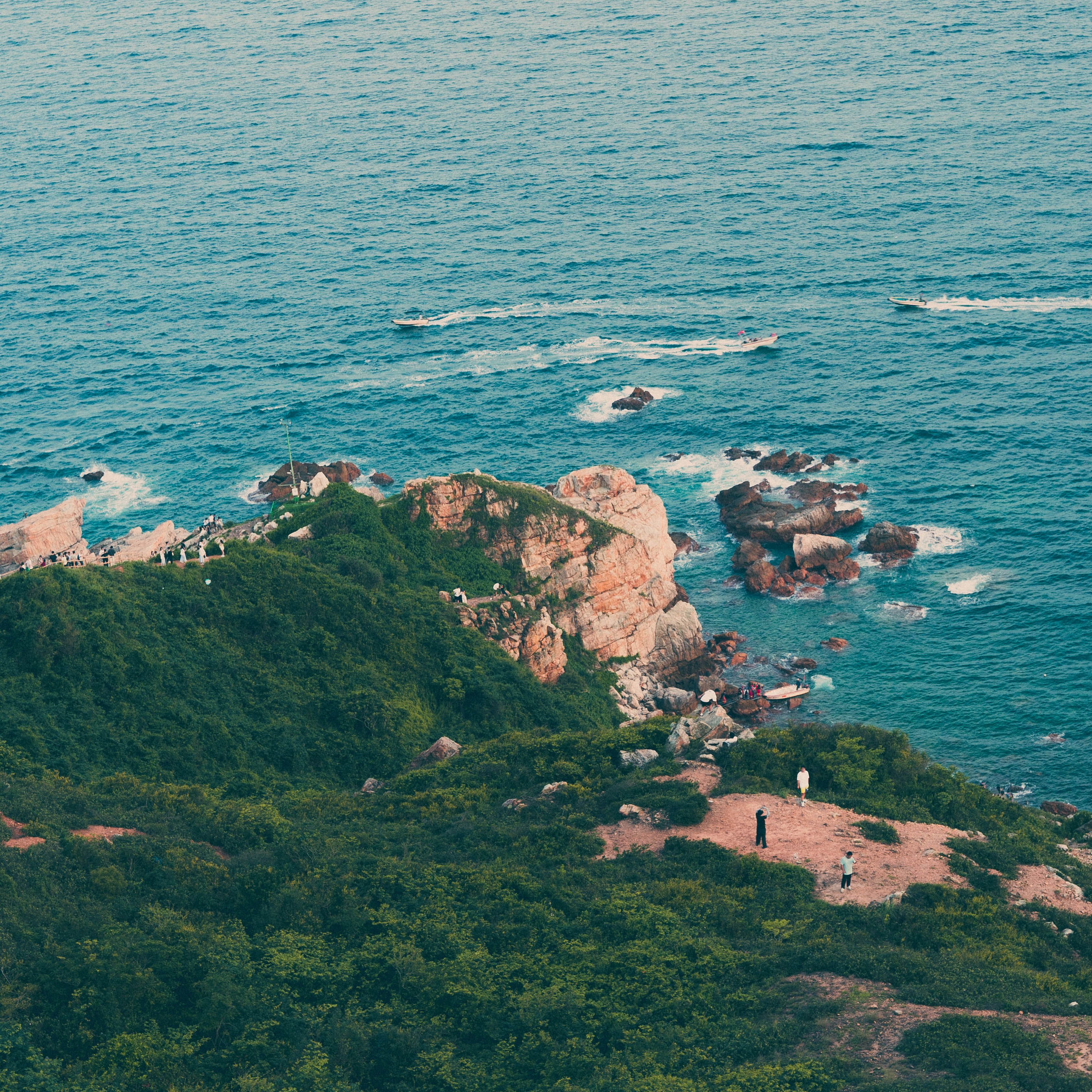 Scenic coastal cliff with lush greenery and ocean view