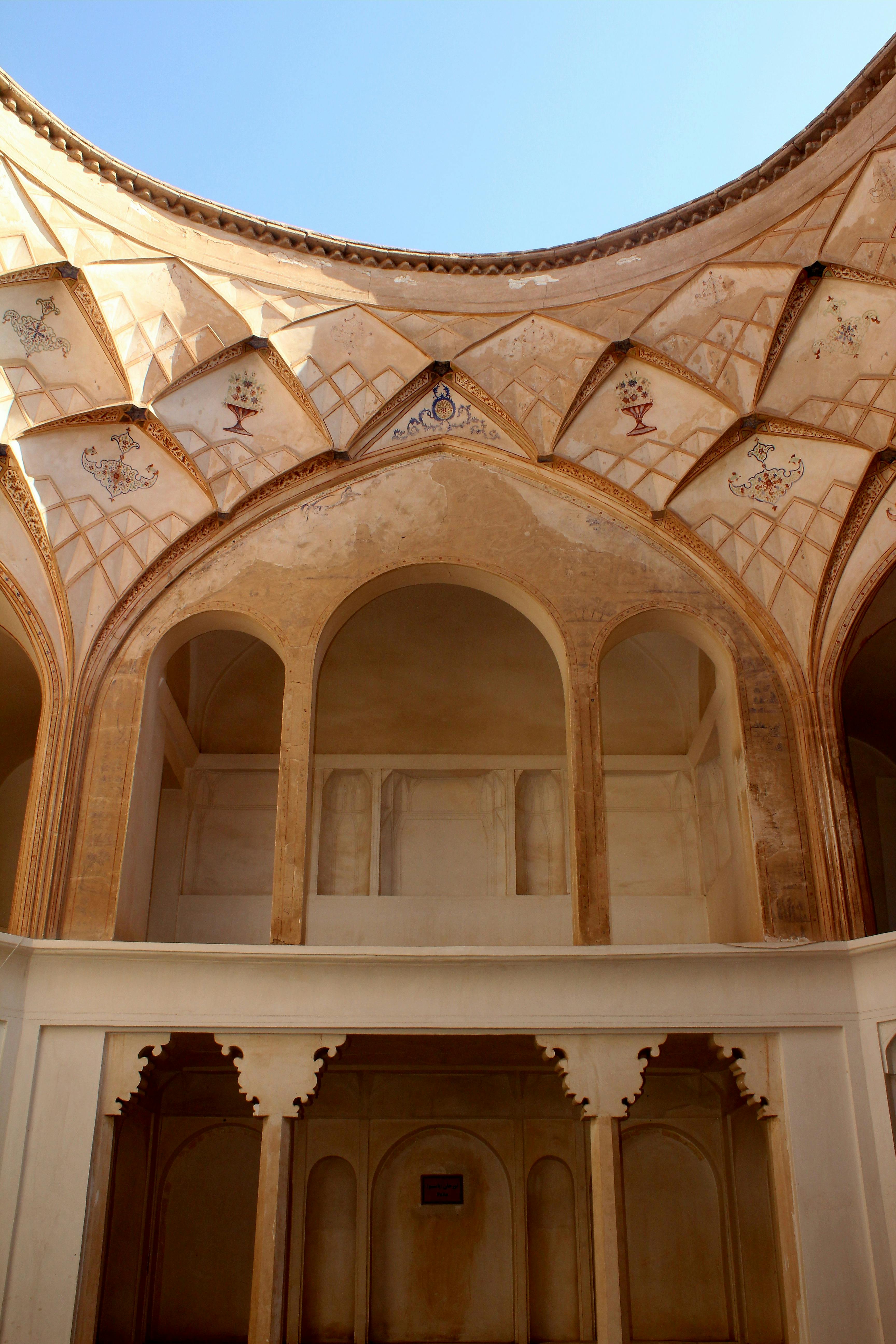 Intricate Persian architectural details inside a historic building, showcasing stunning arches and motifs.