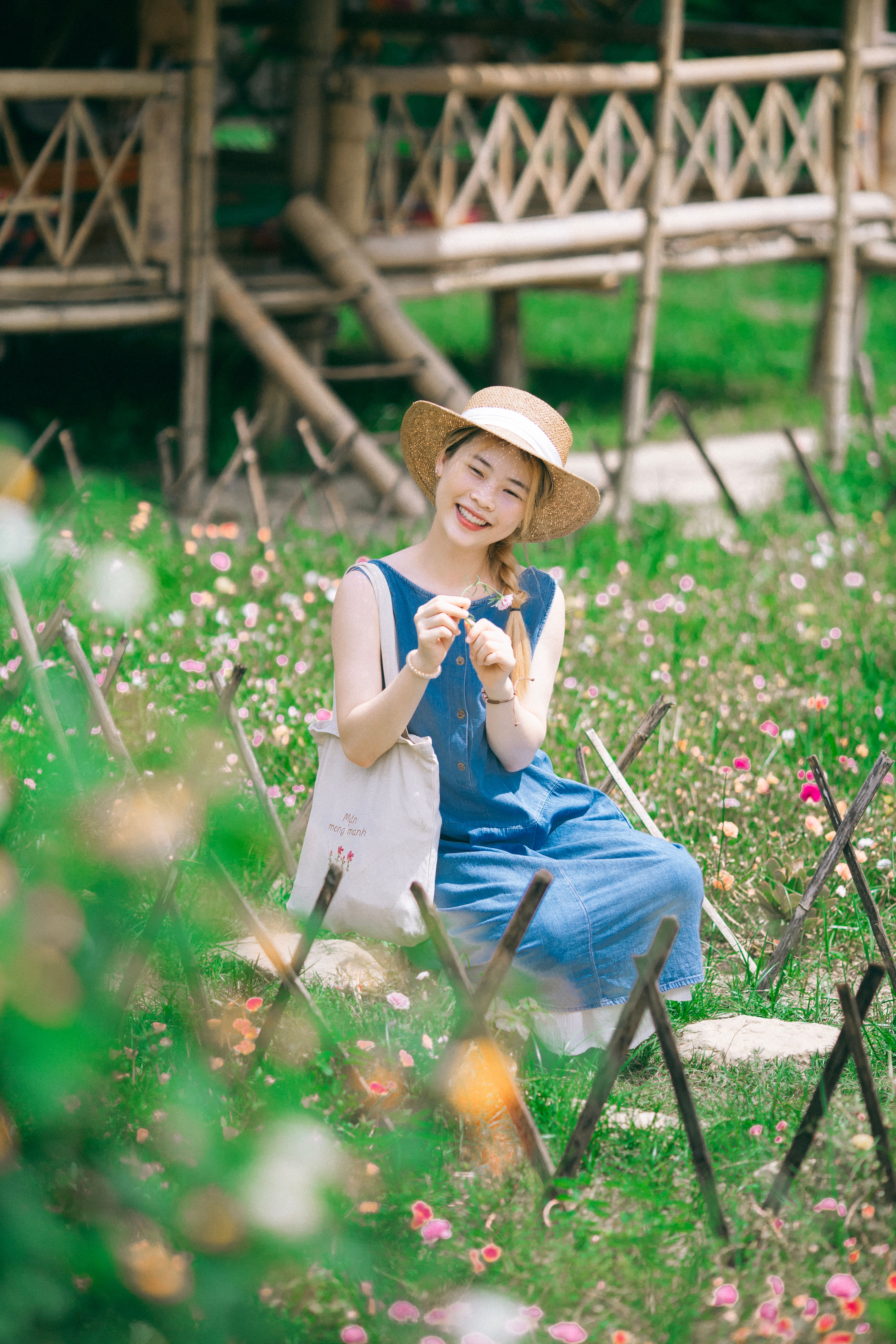 Woman in Garden Wearing Straw Hat Enjoying Summer · Free Stock Photo