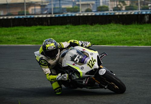 Free Motorcyclist in full gear taking a sharp turn on a race track in Mabalacat, Philippines. Stock Photo