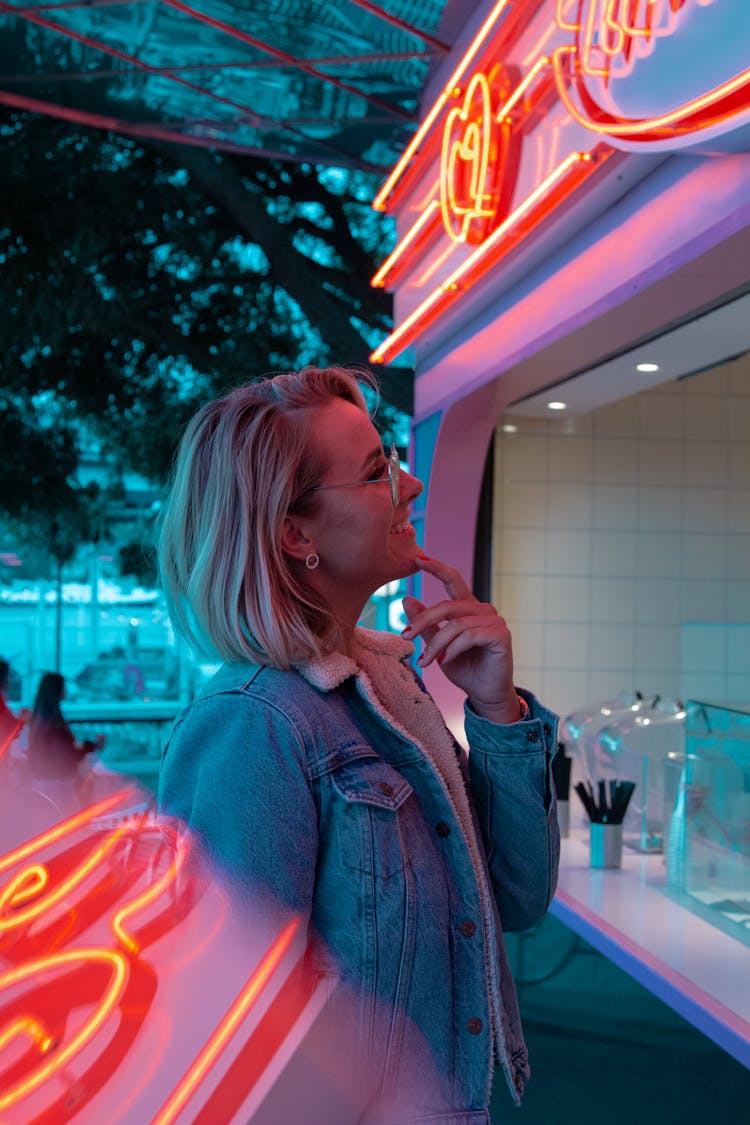 Woman Standing In Front Of Food Stall