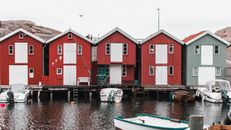 Boats Anchored On A Marina Bay With Houses